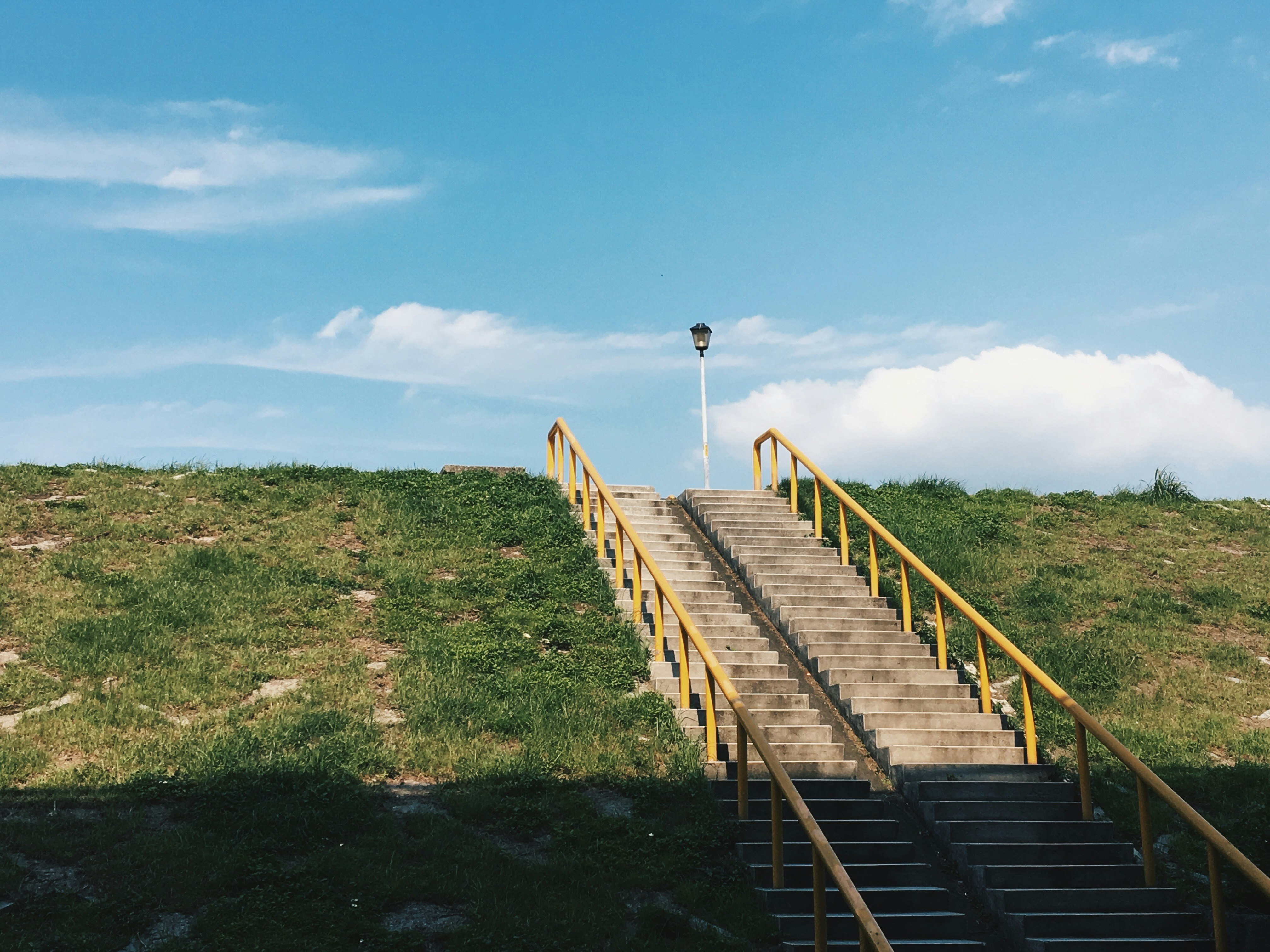 brown concrete stairs under clear blue sky